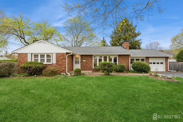 ranch-style house featuring a garage, a chimney, brick siding, and driveway