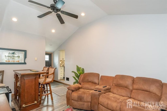 living room featuring lofted ceiling, wood finished floors, recessed lighting, and a ceiling fan