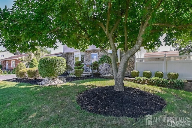 obstructed view of property featuring stone siding