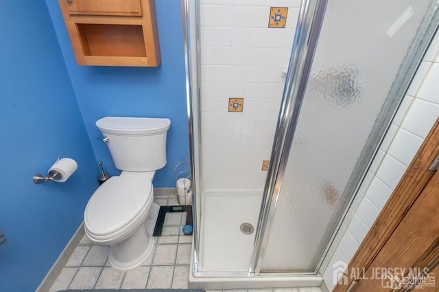 full bath with baseboards, a stall shower, and toilet