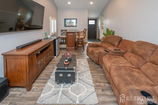 living area with light wood-type flooring and recessed lighting
