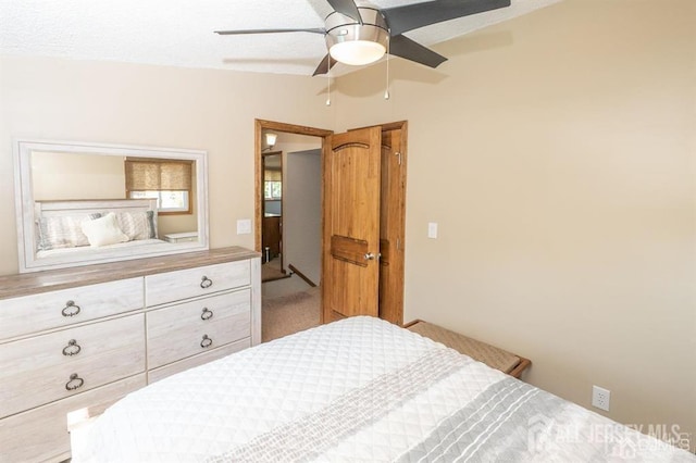 bedroom with ceiling fan, carpet, and lofted ceiling