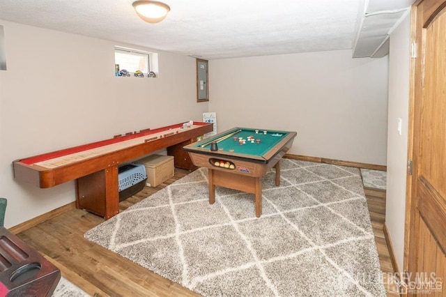 playroom featuring wood finished floors, electric panel, and baseboards