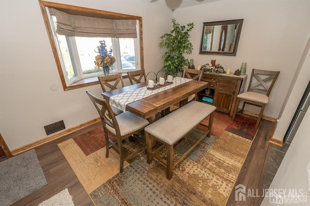 dining space with wood finished floors and baseboards
