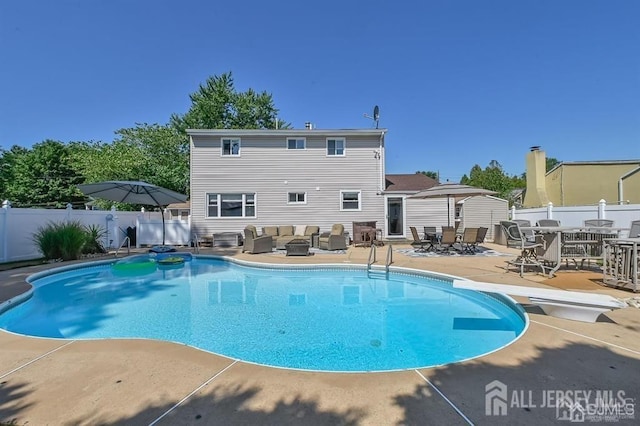 view of pool with an outdoor living space, a fenced backyard, a patio area, outdoor dining area, and a diving board