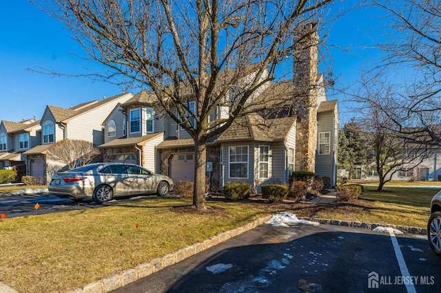 view of front facade with a garage and a front lawn