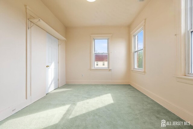 unfurnished bedroom with light colored carpet