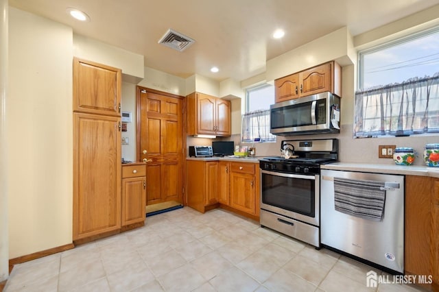 kitchen featuring appliances with stainless steel finishes and decorative backsplash