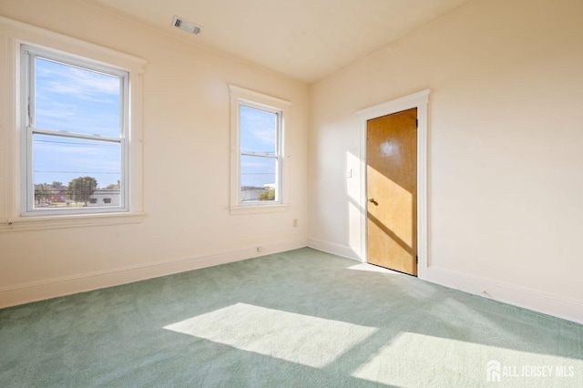 empty room featuring light carpet