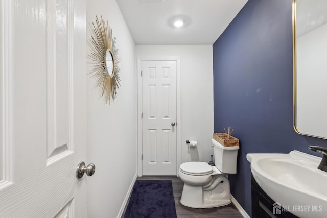 106 Ellsworth Way S, Brunswick, NJ 08852 - half bathroom with a sink, baseboards, toilet, and wood finished floors