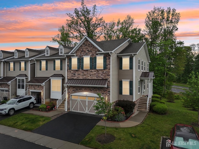 106 Ellsworth Way S, Brunswick, NJ 08852 - multi unit property featuring stone siding, a garage, a lawn, driveway, and a standing seam roof