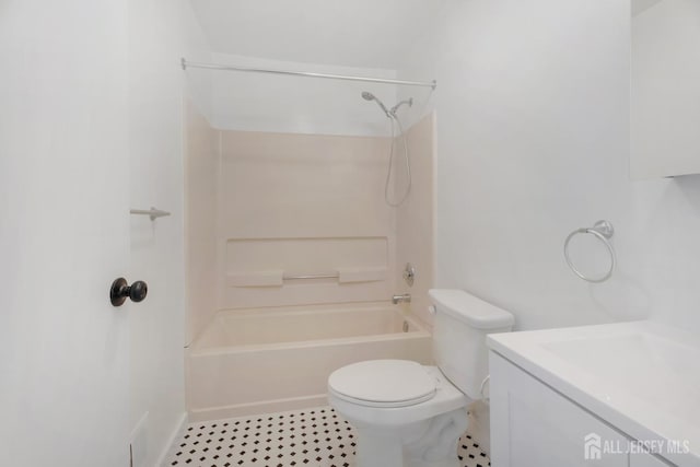 full bath featuring tile patterned flooring, shower / washtub combination, toilet, and vanity