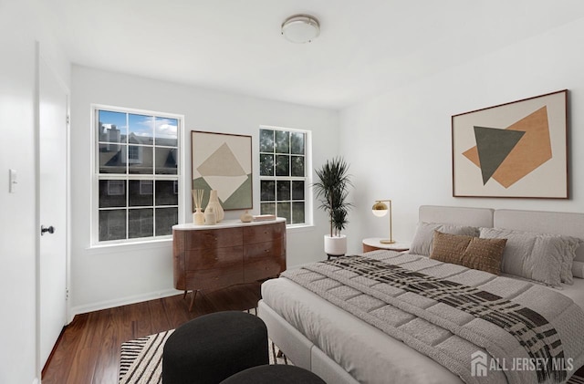 bedroom featuring wood finished floors and baseboards