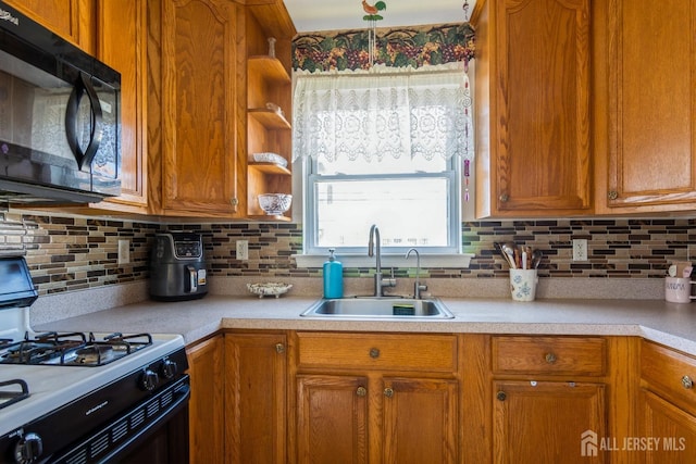 99 William St, South River, NJ 08882 - kitchen with black microwave, gas range oven, light countertops, backsplash, and brown cabinetry