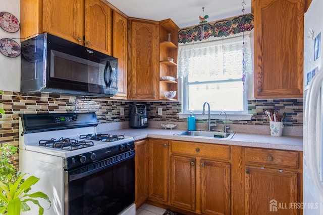 99 William St, South River, NJ 08882 - kitchen with gas range, black microwave, light countertops, and freestanding refrigerator