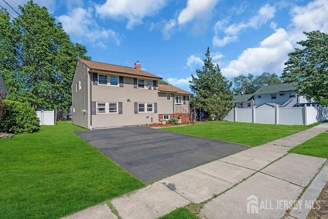 73 Webb Dr, Fords, NJ 08863 - view of front of house featuring a chimney and driveway