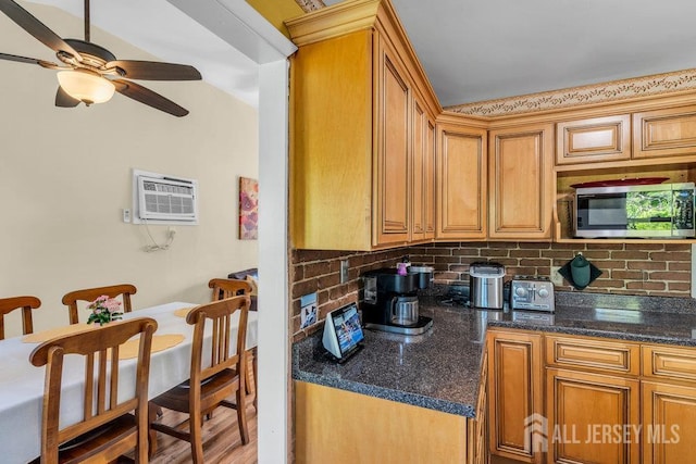 73 Webb Dr, Fords, NJ 08863 - kitchen with stainless steel microwave, tasteful backsplash, an AC wall unit, ceiling fan, and brown cabinetry