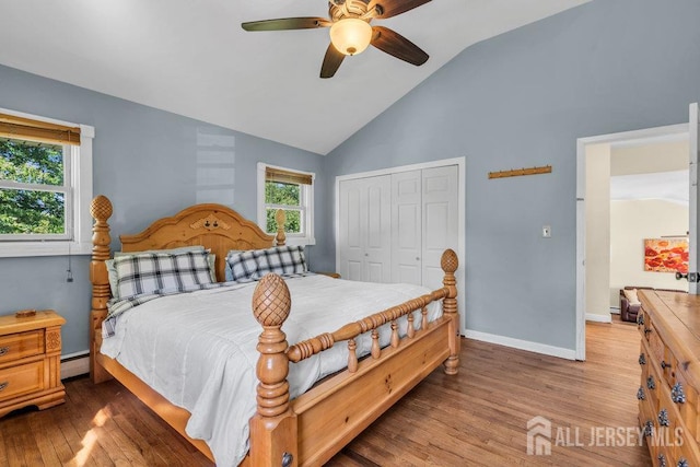 73 Webb Dr, Fords, NJ 08863 - bedroom featuring wood finished floors, a closet, a baseboard radiator, multiple windows, and high vaulted ceiling