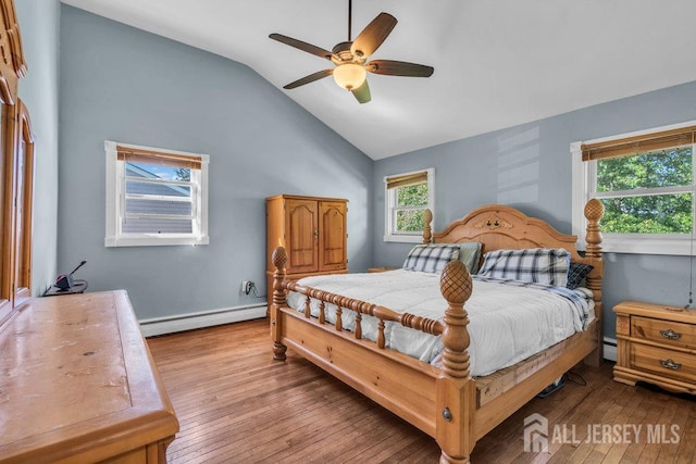73 Webb Dr, Fords, NJ 08863 - bedroom featuring baseboard heating, lofted ceiling, hardwood / wood-style floors, and ceiling fan