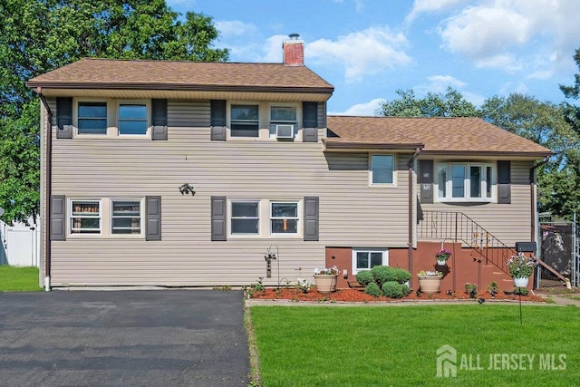 73 Webb Dr, Fords, NJ 08863 - view of front of property with a chimney, a front yard, and cooling unit