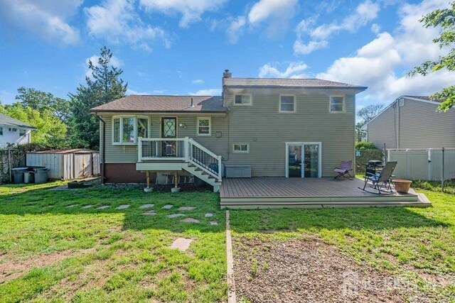 73 Webb Dr, Fords, NJ 08863 - back of house with a fenced backyard, a storage unit, a wooden deck, and a chimney