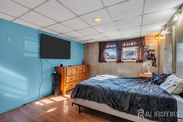 73 Webb Dr, Fords, NJ 08863 - bedroom featuring wood finished floors, wood walls, and a paneled ceiling