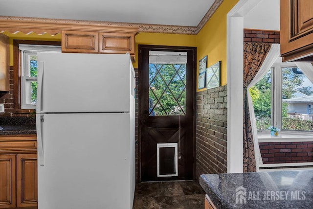 73 Webb Dr, Fords, NJ 08863 - kitchen with freestanding refrigerator, brown cabinets, and dark stone finish flooring