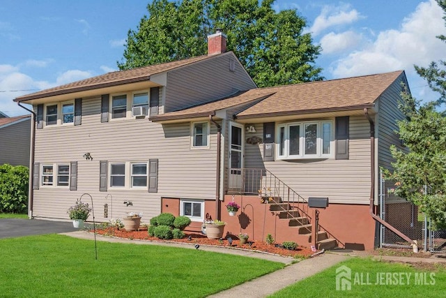 73 Webb Dr, Fords, NJ 08863 - split level home with a front lawn and a chimney