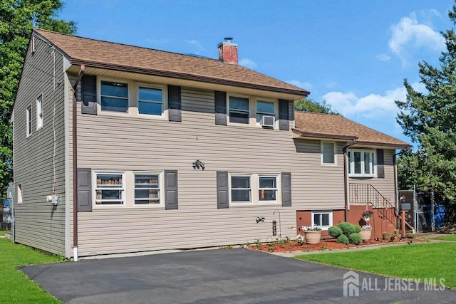 73 Webb Dr, Fords, NJ 08863 - back of property with a chimney, a yard, and roof with shingles