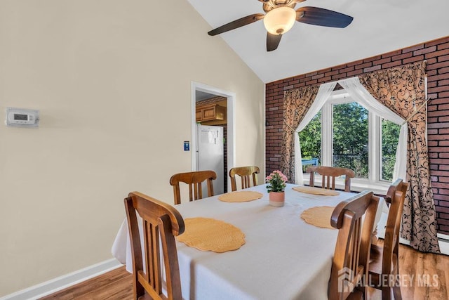 73 Webb Dr, Fords, NJ 08863 - dining room with light wood-type flooring, vaulted ceiling, ceiling fan, and brick wall