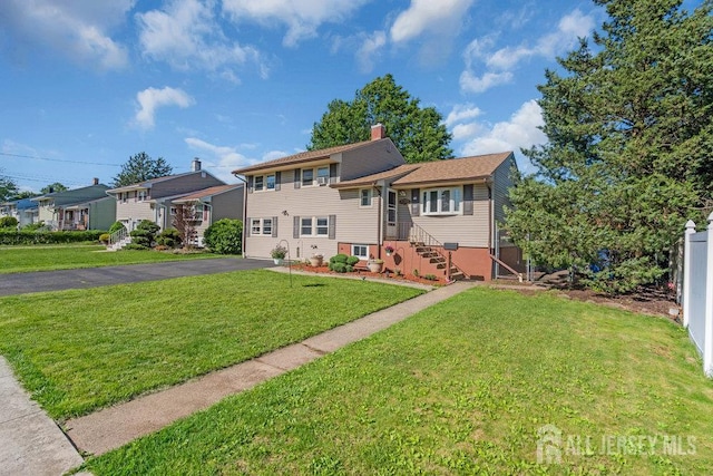 73 Webb Dr, Fords, NJ 08863 - split level home featuring asphalt driveway, a chimney, and a garage