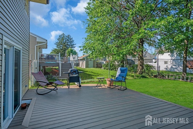 73 Webb Dr, Fords, NJ 08863 - wooden deck with area for grilling and a fenced backyard