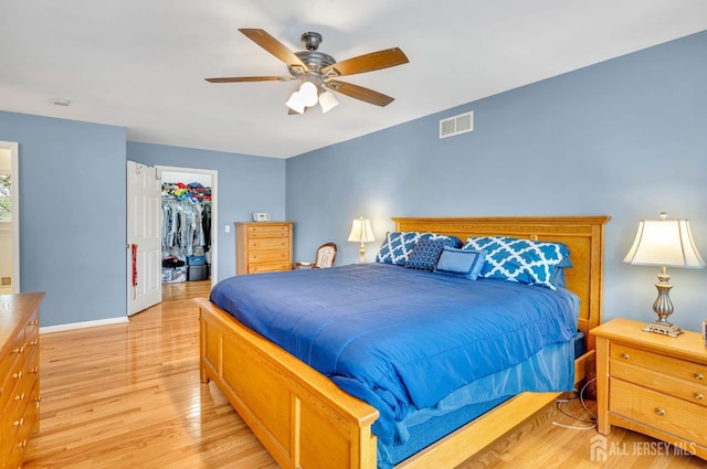 10 Rauer Ct, South Plainfield, NJ 07080 - bedroom with light wood-type flooring, a spacious closet, ceiling fan, and a closet