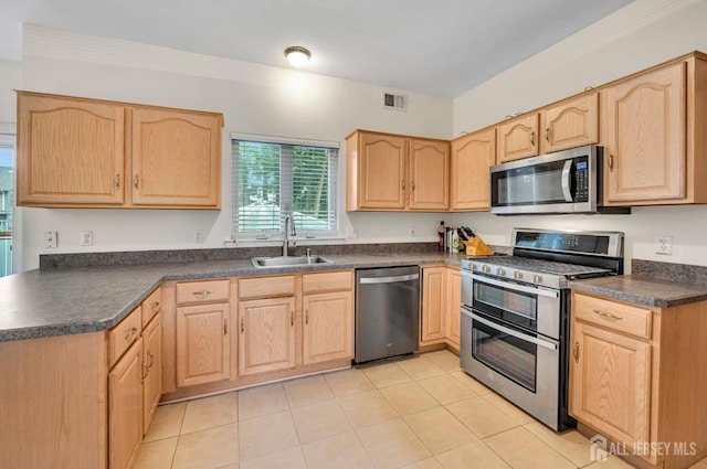 10 Rauer Ct, South Plainfield, NJ 07080 - kitchen with stainless steel appliances, light brown cabinetry, dark countertops, and light tile patterned floors