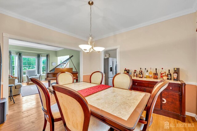 10 Rauer Ct, South Plainfield, NJ 07080 - dining room featuring light wood finished floors, ornamental molding, and a chandelier