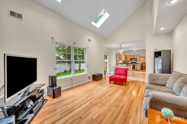 10 Rauer Ct, South Plainfield, NJ 07080 - living area featuring a skylight, high vaulted ceiling, light wood-style flooring, and recessed lighting