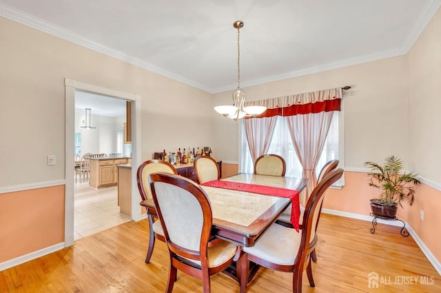 10 Rauer Ct, South Plainfield, NJ 07080 - dining room with healthy amount of natural light, light wood-type flooring, a chandelier, and crown molding