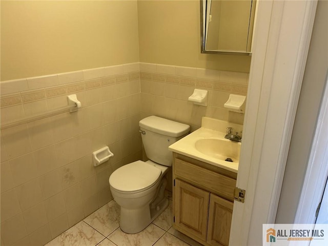 76 Union St Unit A10, Newark, NJ 07105 - bathroom with tile walls, vanity, a wainscoted wall, and marble finish floors