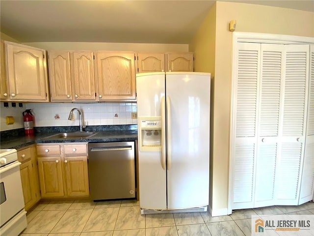 76 Union St Unit A10, Newark, NJ 07105 - kitchen featuring white appliances, dark countertops, light brown cabinetry, light tile patterned floors, and backsplash