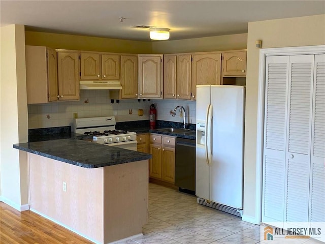 76 Union St Unit A10, Newark, NJ 07105 - kitchen with white appliances, under cabinet range hood, a peninsula, tasteful backsplash, and dark stone countertops