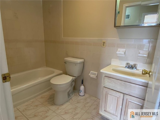 76 Union St Unit A10, Newark, NJ 07105 - bathroom with vanity, tile walls, marble look tiles, a wainscoted wall, and washtub / shower combination