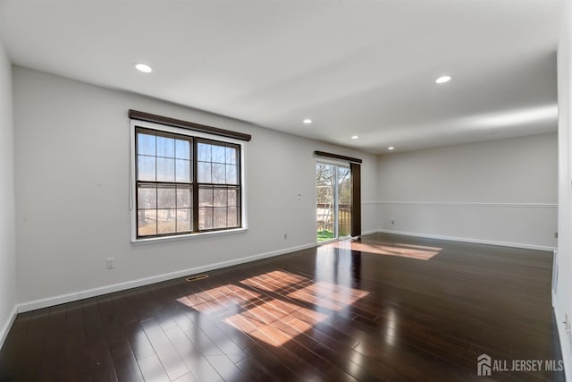 unfurnished room featuring visible vents, recessed lighting, baseboards, and wood finished floors