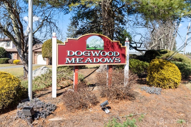 community sign featuring a garage