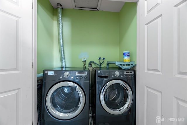 clothes washing area with washing machine and dryer and laundry area