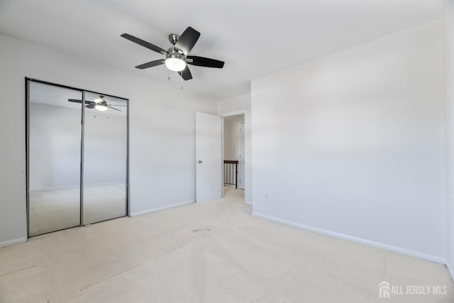 unfurnished bedroom with a closet, ceiling fan, baseboards, and carpet floors