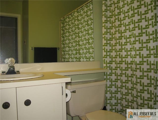 bathroom with toilet and vanity