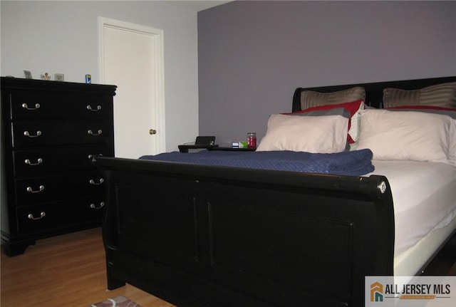 bedroom with wood-type flooring