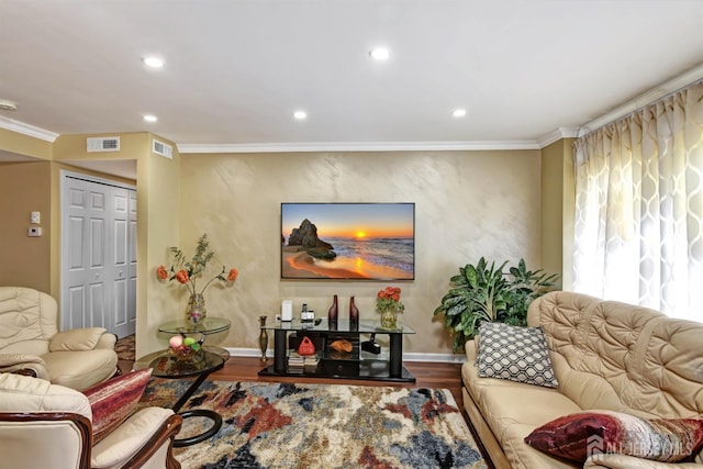 living room with hardwood / wood-style floors and crown molding