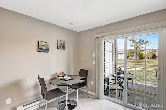 dining room featuring a baseboard radiator and light tile patterned flooring