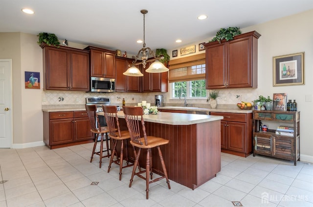 15 Heather Ct, Mansfield, NJ 08022 - kitchen featuring stainless steel microwave, light countertops, backsplash, a center island, and recessed lighting